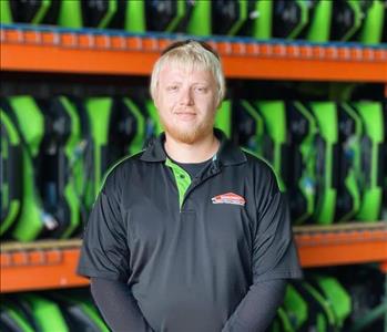 Seth is standing in front of a wall of green air movers